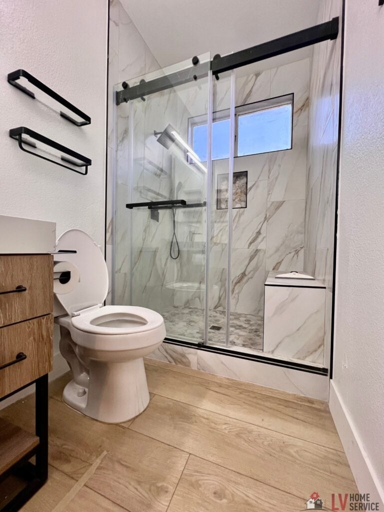 A bathroom with a glass shower door.