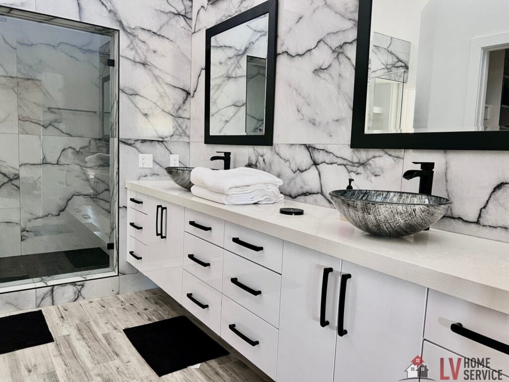 Luxury bathroom featuring a double sink vanity with black fixtures