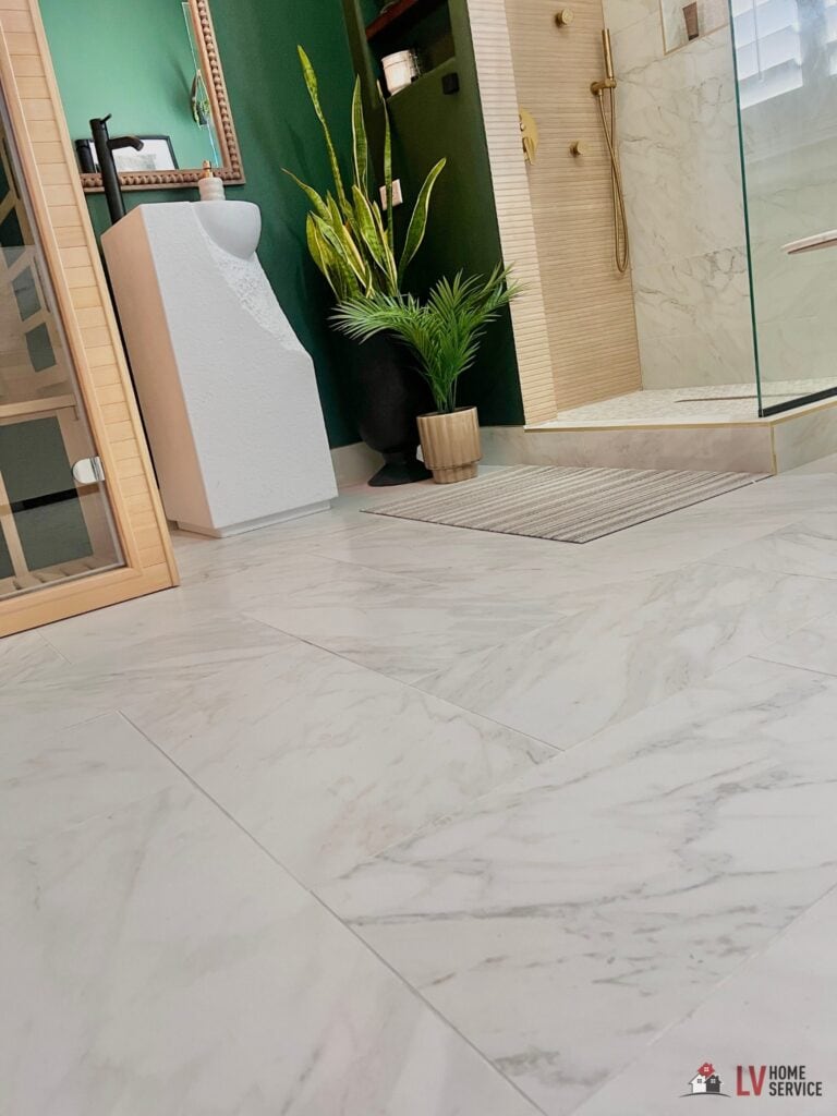 Modern bathroom with white marble floor and glass shower.